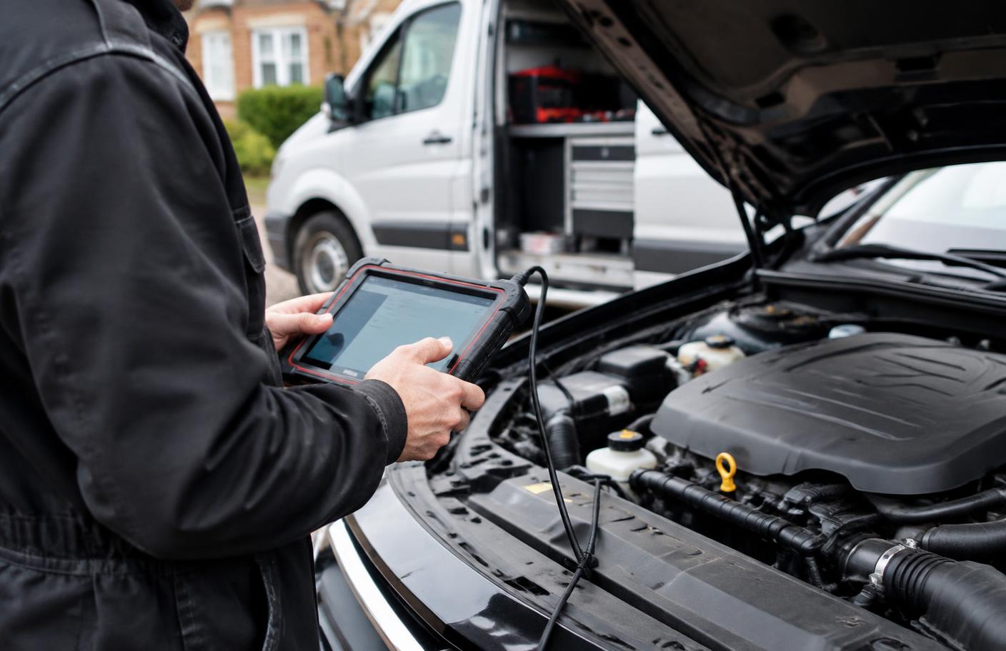 Mobile mechanic diagnosing a car on a driveway
